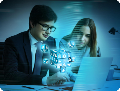 two professionals working together at a laptop, with digital icons and a cube floating in the foreground, suggesting themes of technology, innovation, or digital collaboration.